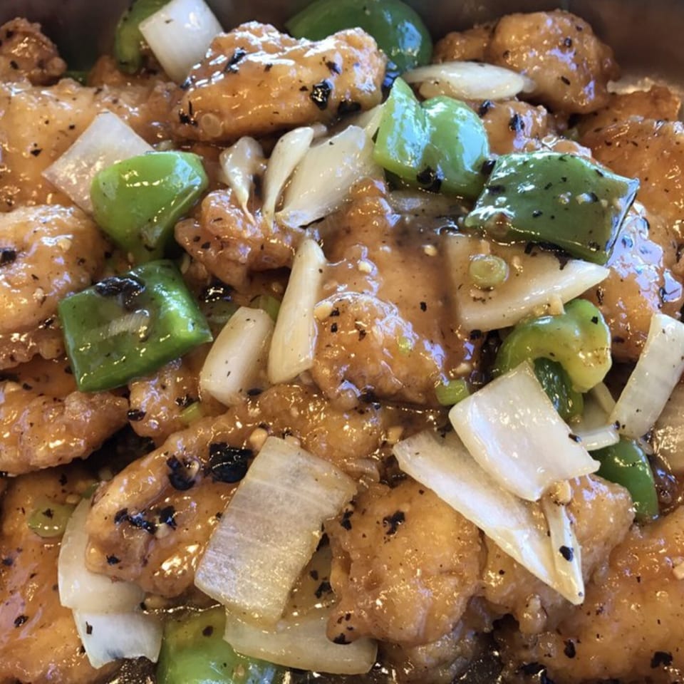 Wong's Wok Chinese Kitchen's black pepper chicken with green peppers and onions in a savory sauce.