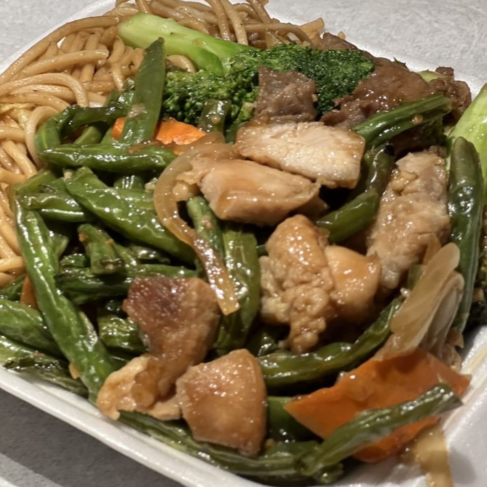 Wong's Wok Chinese Kitchen's chicken and beef stir-fry with noodles, green beans, broccoli, and carrots.